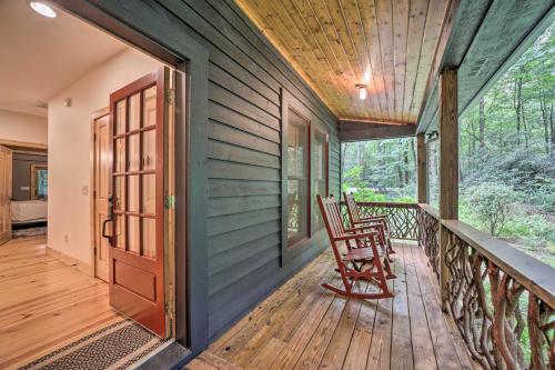a wooden porch with a rocking chair on a deck at Secluded Sapphire Chalet with Game Room and Decks in Sapphire