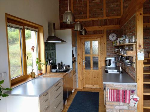a kitchen with wooden walls and a counter top at Nature Homestay in Trenčín