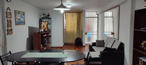 a living room with a table and a couch at Apartamento Marco Airport in Lima