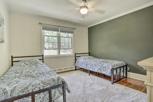 a bedroom with two beds and a window at Serene Hopatcong Cottage with 50-Foot Dock! in Hopatcong