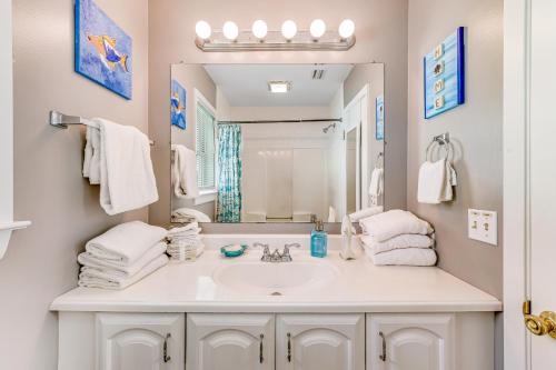 a bathroom with a sink and a mirror at Sand Trap by Meyer Vacation Rentals in Gulf Shores