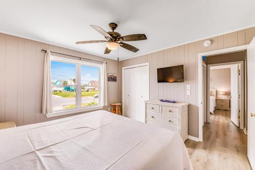 a bedroom with a bed and a ceiling fan at Sand Trap by Meyer Vacation Rentals in Gulf Shores