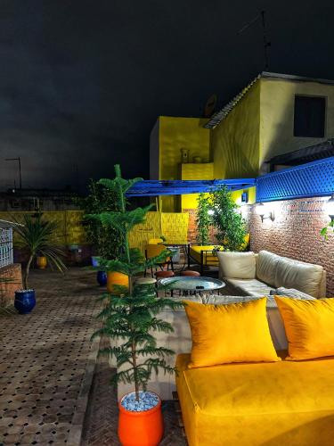 a patio with a couch and a table with plants at Riad Majorelle in Rabat