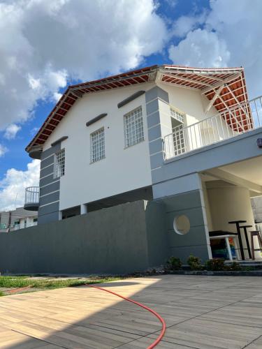 a house with a red hose in front of it at Casa em ótima localização in Boa Vista
