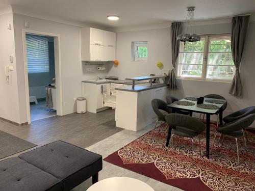 uma cozinha e sala de estar com mesa e cadeiras em Stefánia Apartmanok Budapest em Budapeste