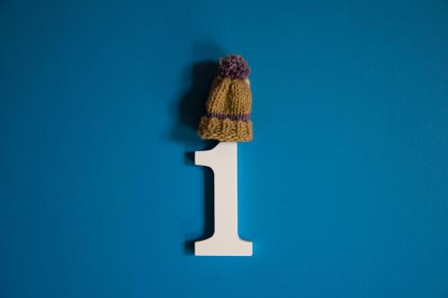 a knitted cap on top of a white number one at Hostal Mundo Nuevo in Ancud