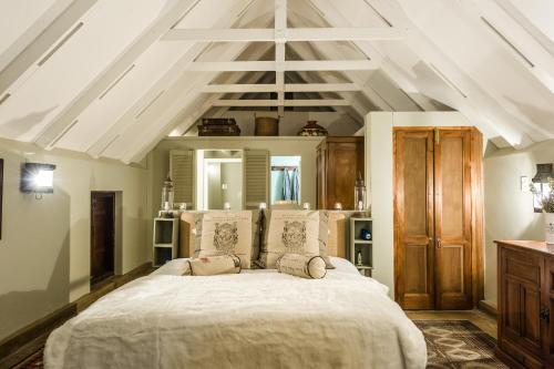 a bedroom with a large white bed in a room at The Oystercatchers Haven at Paternoster in Paternoster