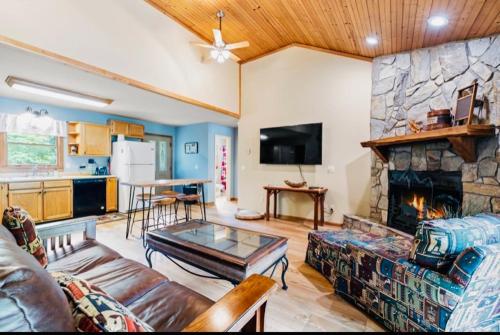 a living room with a couch and a fireplace at River's Edge in Cullowhee