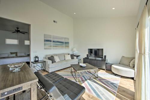 a living room with a couch and a table at Modern Cedar Creek Lake Retreat with Panoramic View! in Malakoff