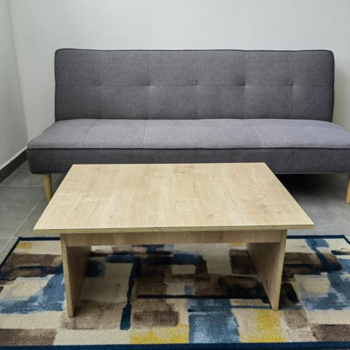 a wooden coffee table in front of a couch at San Martin- Moderno y confortable apartaestudio sector rosales in Manizales