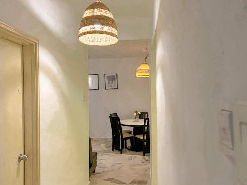 a hallway leading to a dining room with a table at BayView Suites Port Dickson By MAISON in Port Dickson