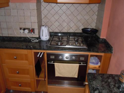 a kitchen with a stove and a counter top at D-House in Birgu