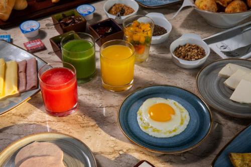 a table topped with plates of breakfast foods and drinks at Novotel Sao Paulo Morumbi in Sao Paulo