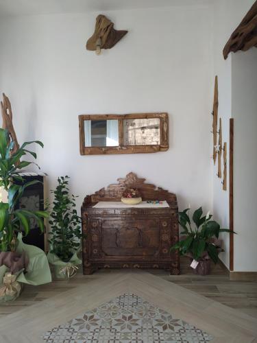 a room with a bed and a mirror on the wall at B&B Steddueoro in Baunei