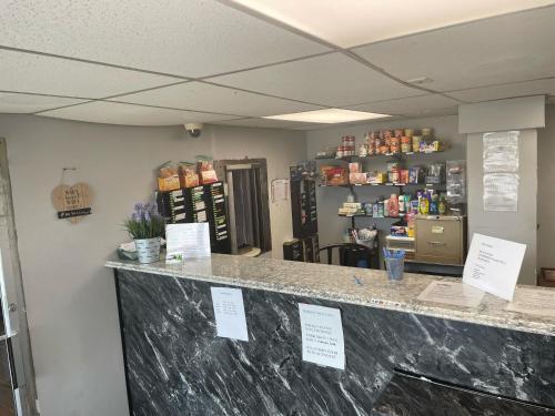 a counter in a store with signs on it at Budgetel Inn and Suites - Louisville in Louisville