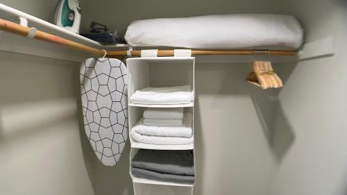 a room with a shelf with a bed and towels at ViewPoint Suites in Los Angeles