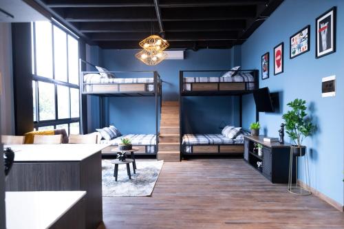 a room with two bunk beds and a couch at Royal Living Poblado in Medellín