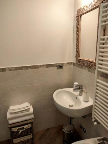 a white bathroom with a sink and a mirror at Al San Lorenzo in Bergamo