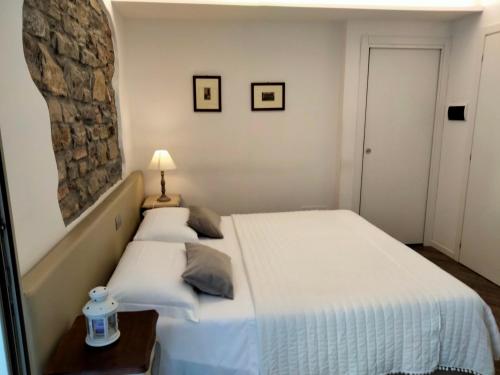 a bedroom with a bed and a stone wall at Al San Lorenzo in Bergamo