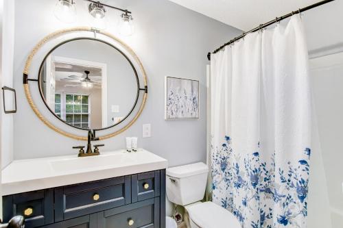 a bathroom with a sink and a mirror at The Wilmington Condos Island in Savannah