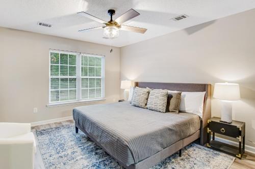 a bedroom with a bed and a ceiling fan at The Wilmington Condos Island in Savannah