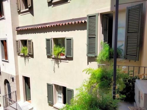 an apartment building with windows with green shutters at Al San Lorenzo in Bergamo