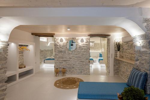 a living room with a stone wall at Margaret's Houses in TINOS Town in Tinos
