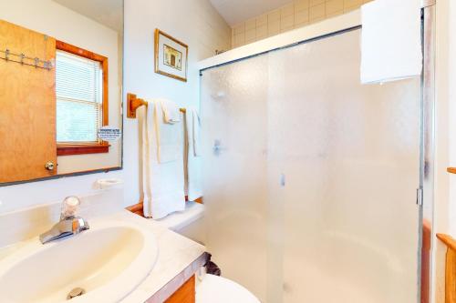 a bathroom with a sink and a shower at Pirate's Light #73-B in Buxton
