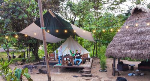 a group of people sitting in a tent at Finca de la Vaca - Glamping in Palora