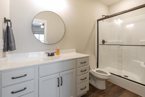 a bathroom with a sink and a toilet and a mirror at Brand New! Lake View with Arcade Game Room! Fully stocked kitchen! in Hollister