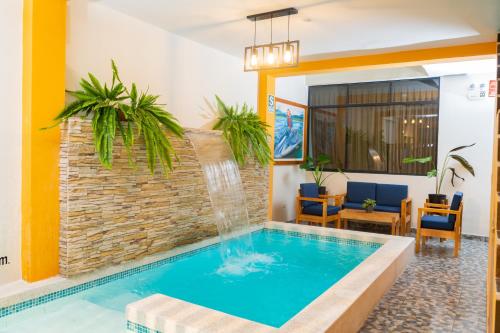 a swimming pool with a fountain in a living room at Fanda in Sauce