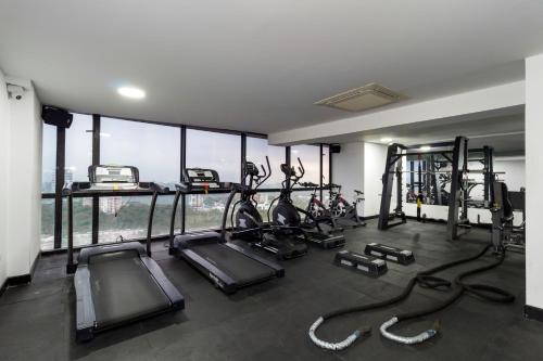 a gym with several treadmills and elliptical machines at Hotel Mocawa Plaza Armenia in Armenia