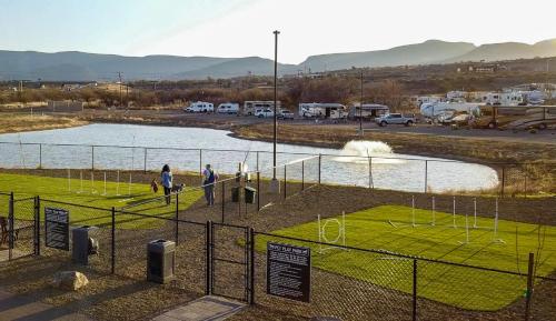 a group of people walking around a soccer field at Verde Ranch RV Resort in Camp Verde
