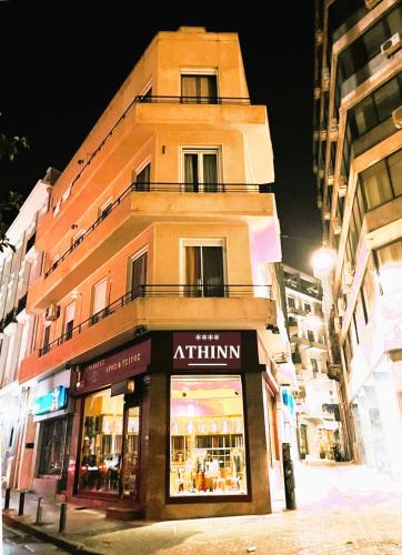 a building on a city street at night at AthINN Residence in Athens