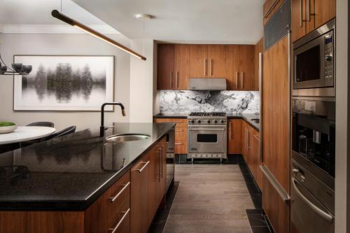 a kitchen with wooden cabinets and black counter tops at Four Seasons Resort Whistler in Whistler