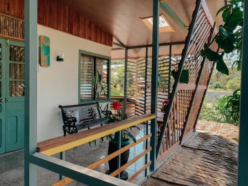 a porch with a bench on a house at Orgánico Punta Riel in Cahuita