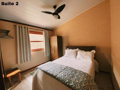 1 dormitorio con 1 cama y ventilador de techo en Casa de Campo no Caravaggio ao lado da Cervejaria Três Santas en Santa Teresa
