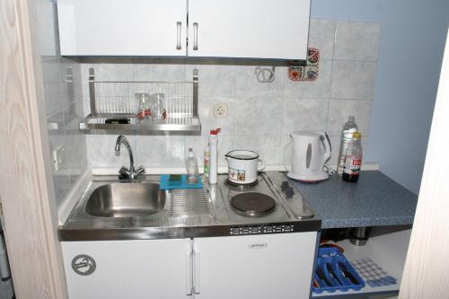 a small kitchen with a sink and a counter top at Apartments by the sea Promajna, Makarska - 2642 in Promajna