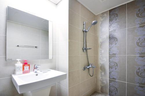 a bathroom with a sink and a shower at Jeju Resort in Jeju