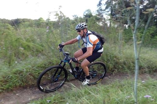 a man riding a bike down a dirt road at Kingaley Farmstay in Fosterton