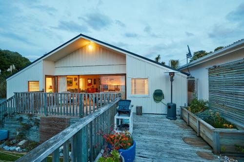 a house with a deck with a chair on it at A Room With a View in Kaikoura