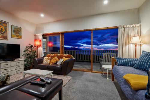 a living room with a couch and a television at A Room With a View in Kaikoura