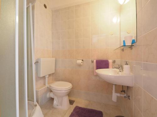 a bathroom with a toilet and a sink at Apartments and rooms by the sea Slano, Dubrovnik - 2682 in Slano