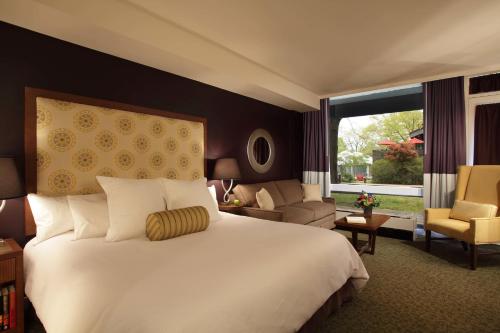 a bedroom with a large bed and a living room at Chauncey Hotel and Conference Center in Princeton
