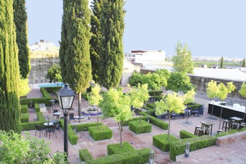 a park with trees and tables and a street light at Hospedería Convento de Santa Clara in Palma del Río