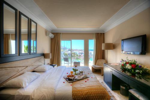 a hotel room with a large bed and a television at Casablanca Le Lido Thalasso & Spa (ex Riad Salam) in Casablanca