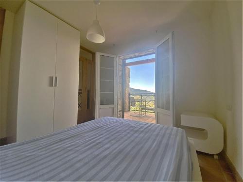a bedroom with a bed and a view of the ocean at Welcoming villa in Torres with private pool in Torres