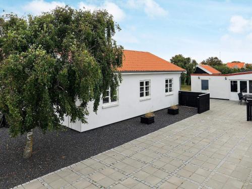 a white house with an orange roof at 8 person holiday home in Skagen-By Traum in Skagen