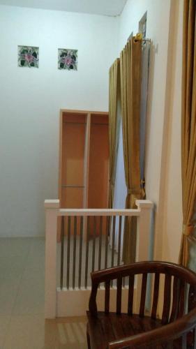 a room with a staircase with a chair and a curtain at Bintang Bungalow Tour & Travel in Kelimutu