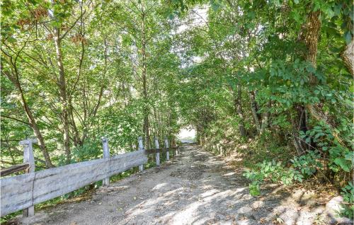 a dirt road with trees and a fence at Nice Apartment In Santo Stefano D'aveto in Santo Stefano dʼAveto
